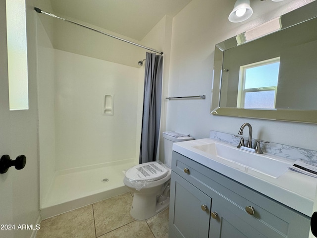 bathroom featuring vanity, toilet, tile patterned floors, and a shower with curtain