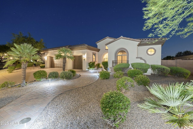5243 E Windstone Trl, Cave Creek, AZ 85331 - mediterranean / spanish-style home featuring stucco siding, an attached garage, a tile roof, and driveway