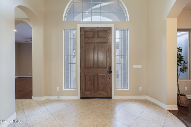 5243 E Windstone Trl, Cave Creek, AZ 85331 - entrance foyer with arched walkways, tile patterned flooring, and a ceiling fan