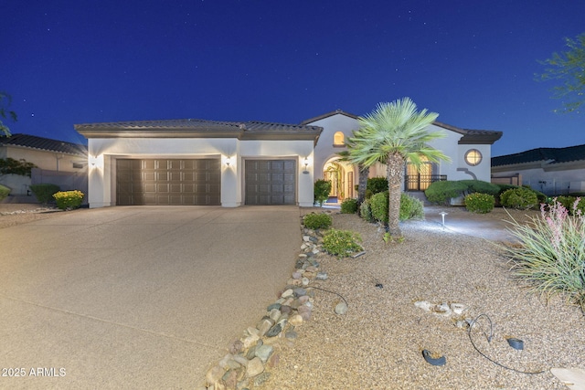 5243 E Windstone Trl, Cave Creek, AZ 85331 - mediterranean / spanish-style house with an attached garage, driveway, stucco siding, and a tiled roof