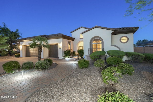 5243 E Windstone Trl, Cave Creek, AZ 85331 - mediterranean / spanish-style home featuring driveway, an attached garage, stucco siding, and a tile roof