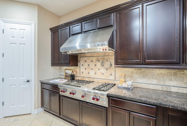 5243 E Windstone Trl, Cave Creek, AZ 85331 - kitchen with under cabinet range hood, dark brown cabinets, tasteful backsplash, and light tile patterned floors
