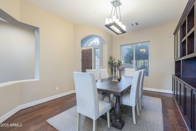 5243 E Windstone Trl, Cave Creek, AZ 85331 - dining room with dark wood-type flooring, a chandelier, and arched walkways