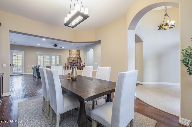 5243 E Windstone Trl, Cave Creek, AZ 85331 - dining space featuring a chandelier, arched walkways, dark wood-type flooring, ceiling fan, and recessed lighting