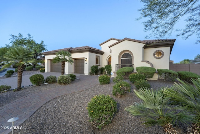 5243 E Windstone Trl, Cave Creek, AZ 85331 - mediterranean / spanish house with a tile roof, stucco siding, an attached garage, and driveway