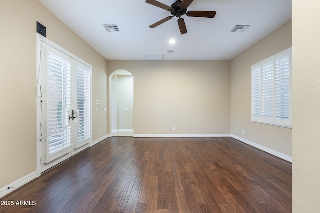 5243 E Windstone Trl, Cave Creek, AZ 85331 - spare room featuring arched walkways, a ceiling fan, and wood finished floors