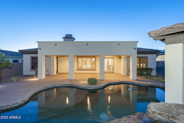 5243 E Windstone Trl, Cave Creek, AZ 85331 - back of property with french doors, stucco siding, a tile roof, a patio, and an outdoor pool