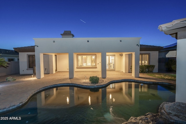 5243 E Windstone Trl, Cave Creek, AZ 85331 - back of property with french doors, stucco siding, a patio, and an outdoor pool