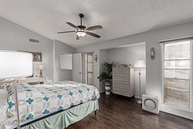 bedroom with a textured ceiling, ceiling fan, dark hardwood / wood-style flooring, and lofted ceiling