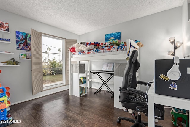 bedroom with dark wood-type flooring and a textured ceiling