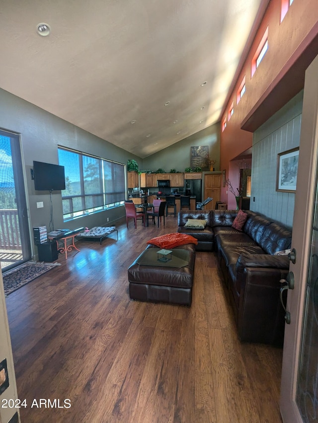 living room featuring lofted ceiling and hardwood / wood-style floors