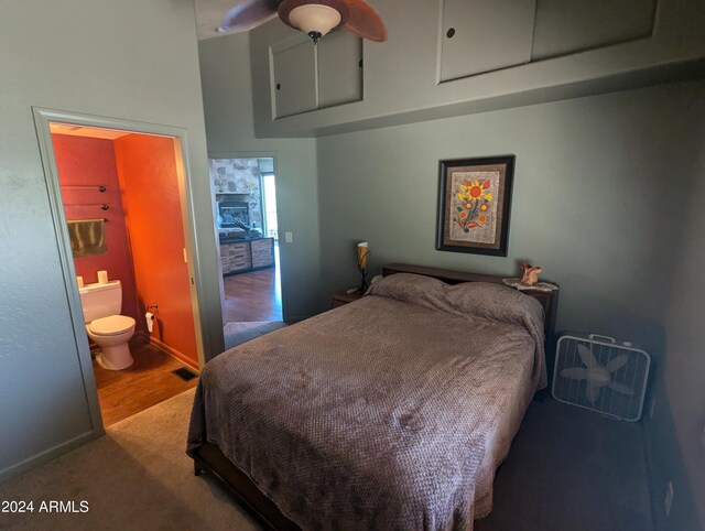 bedroom featuring connected bathroom, ceiling fan, and wood-type flooring