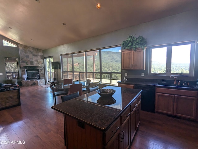 kitchen with dishwasher, sink, dark hardwood / wood-style flooring, and a center island