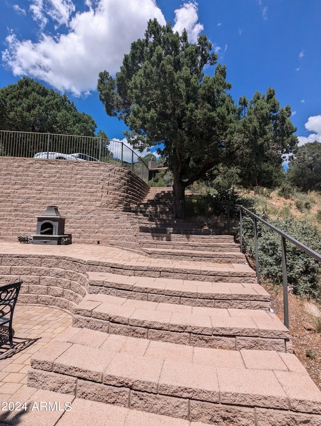 view of patio with a fireplace