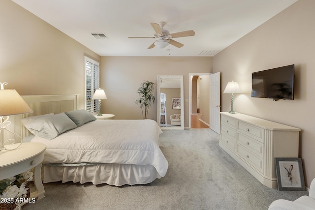 bedroom with ceiling fan and light colored carpet