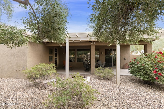 back of property featuring a patio