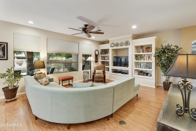 living room featuring light wood-type flooring and ceiling fan