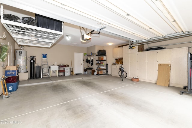 garage featuring a garage door opener and water heater