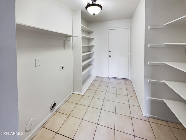 washroom with hookup for a gas dryer, electric dryer hookup, and light tile patterned flooring