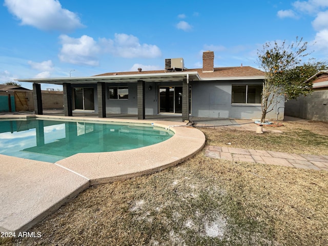 view of pool featuring a patio and central AC