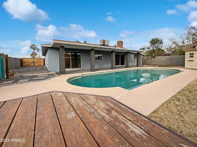 view of swimming pool with a deck