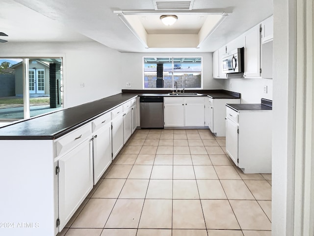 kitchen with white cabinets, stainless steel appliances, and kitchen peninsula