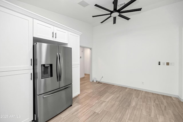 19401 W Flower St, Litchfield Park, AZ 85340 - kitchen featuring stainless steel fridge, a ceiling fan, white cabinetry, baseboards, and light wood-style floors