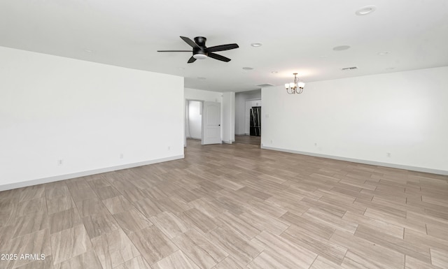 19401 W Flower St, Litchfield Park, AZ 85340 - unfurnished room featuring a chandelier, a ceiling fan, baseboards, light wood-style flooring, and recessed lighting