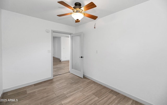 19401 W Flower St, Litchfield Park, AZ 85340 - unfurnished room with baseboards, a ceiling fan, light wood-style flooring, and a smoke detector