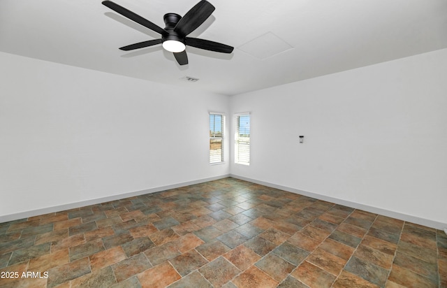 19401 W Flower St, Litchfield Park, AZ 85340 - empty room with stone finish floors, a ceiling fan, and baseboards