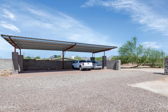 19401 W Flower St, Litchfield Park, AZ 85340 - view of vehicle parking with a detached carport and gravel driveway