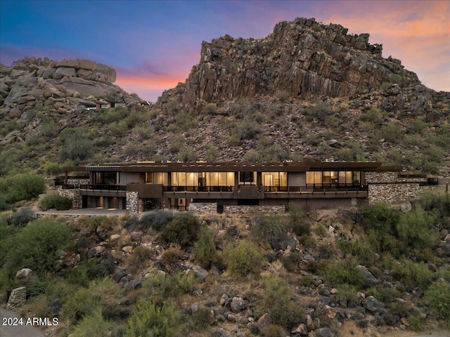 back house at dusk with a mountain view