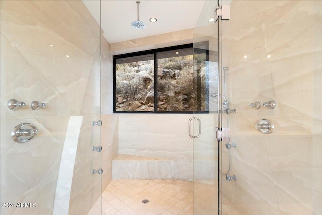 bathroom featuring a shower with door