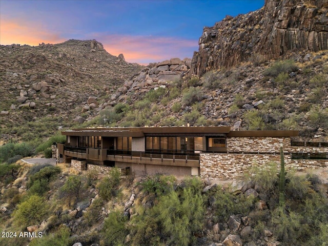 back house at dusk with a mountain view