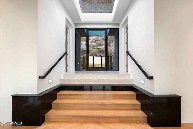 stairway with hardwood / wood-style flooring