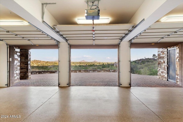 garage with a garage door opener and a mountain view