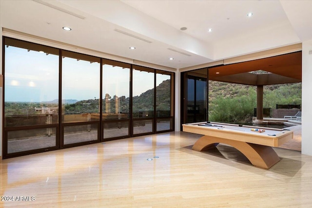 rec room with light hardwood / wood-style floors, billiards, and a mountain view