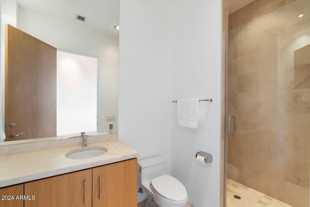 bathroom featuring vanity, toilet, and an enclosed shower