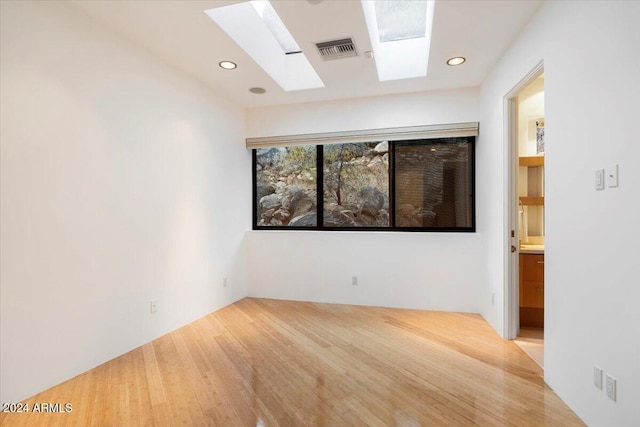 unfurnished room with wood-type flooring