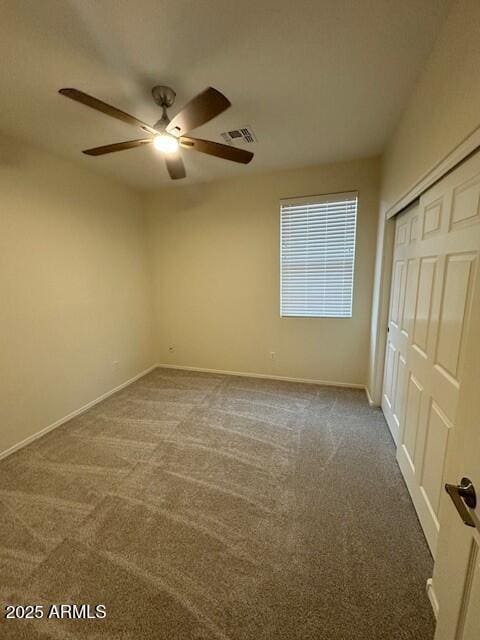 unfurnished bedroom featuring a closet, ceiling fan, and carpet