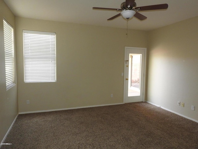 carpeted spare room with ceiling fan