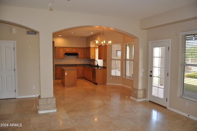 kitchen with a kitchen island, a notable chandelier, hanging light fixtures, stainless steel dishwasher, and sink