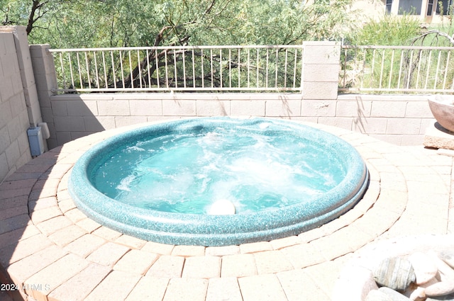 view of swimming pool featuring an outdoor hot tub