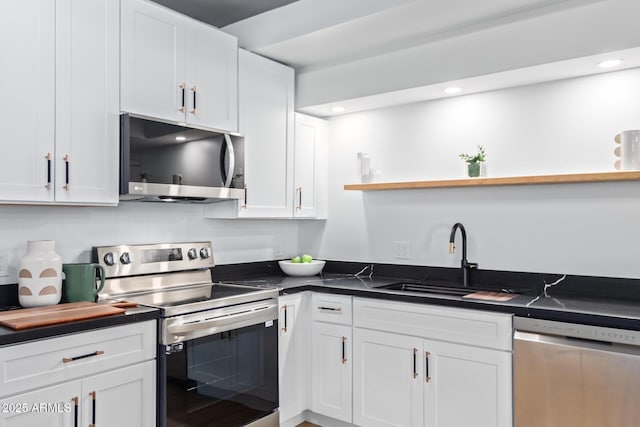 kitchen featuring sink, stainless steel appliances, and white cabinetry