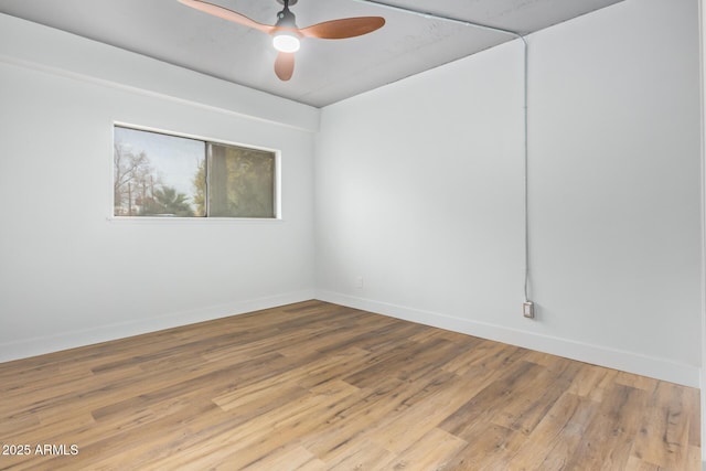 empty room with ceiling fan and hardwood / wood-style floors