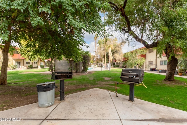 surrounding community with a lawn and a patio