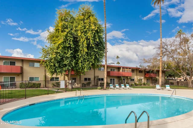 view of pool with a yard