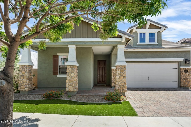 craftsman house featuring covered porch and a garage