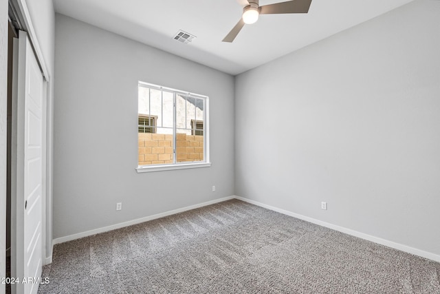 empty room with carpet flooring and ceiling fan