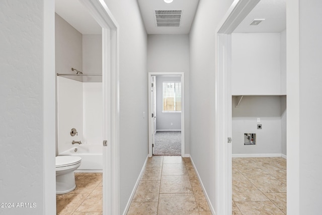 corridor with light tile patterned floors